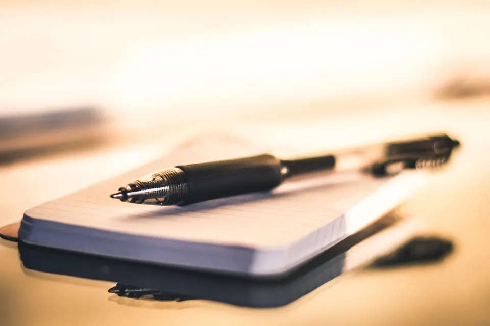 Notepad and pen on a desk ready for planning website content